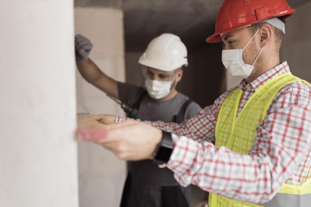 medium shot men working with masks